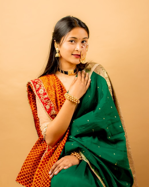 Woman in a green and orange saree