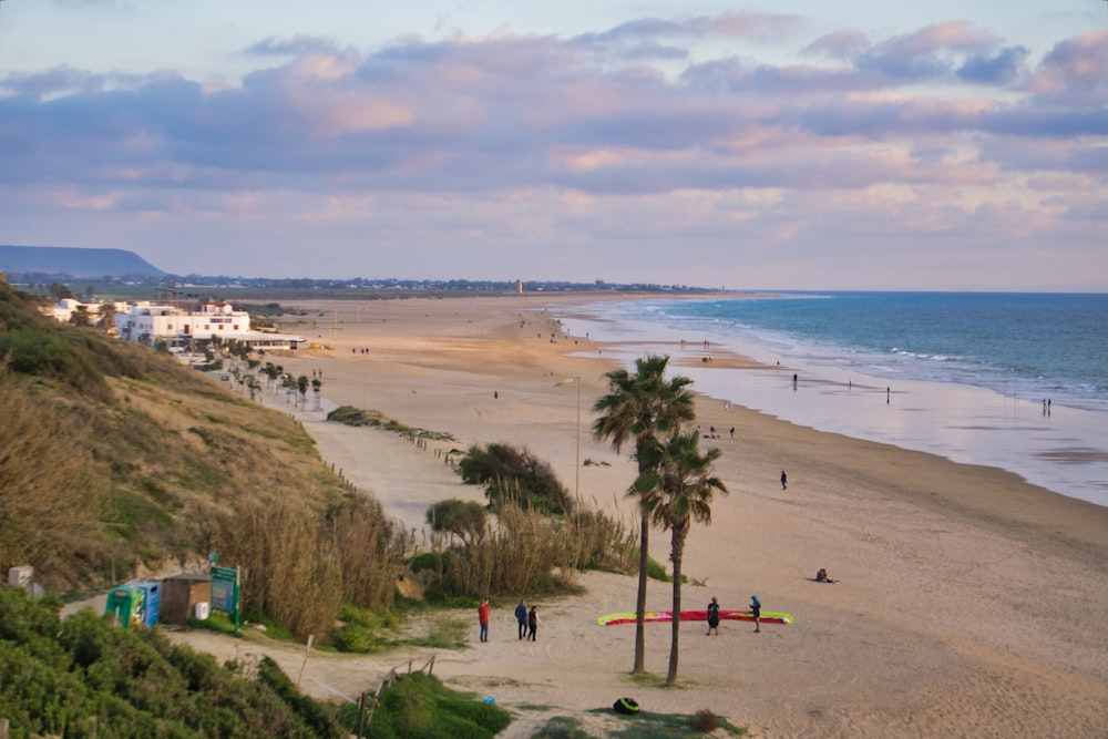 a view of a beach with people walking on it