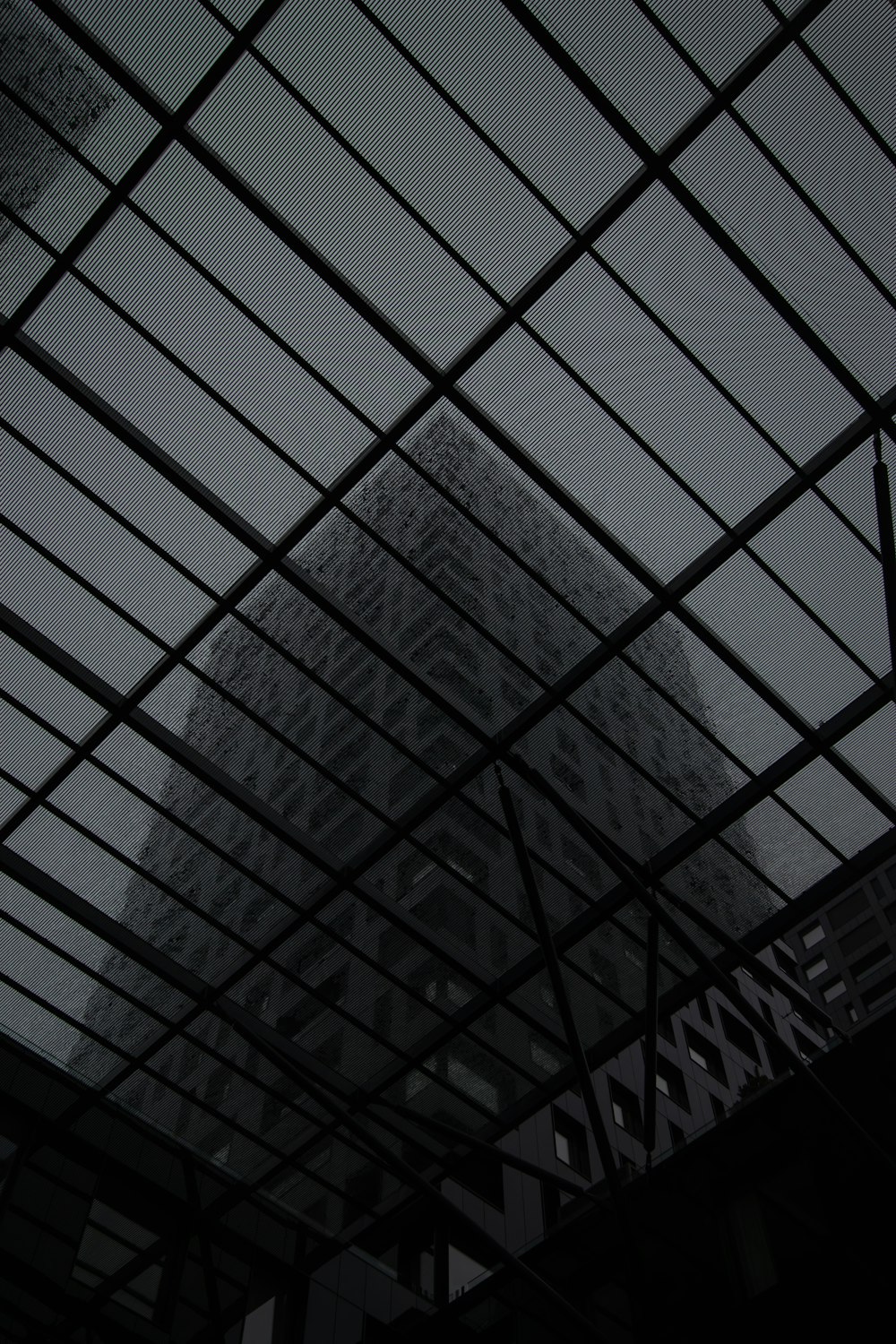 a view of a building through a glass roof