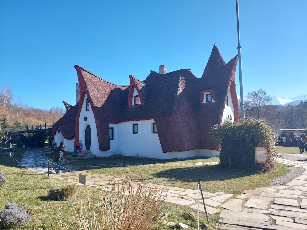 a white and brown house with a red roof