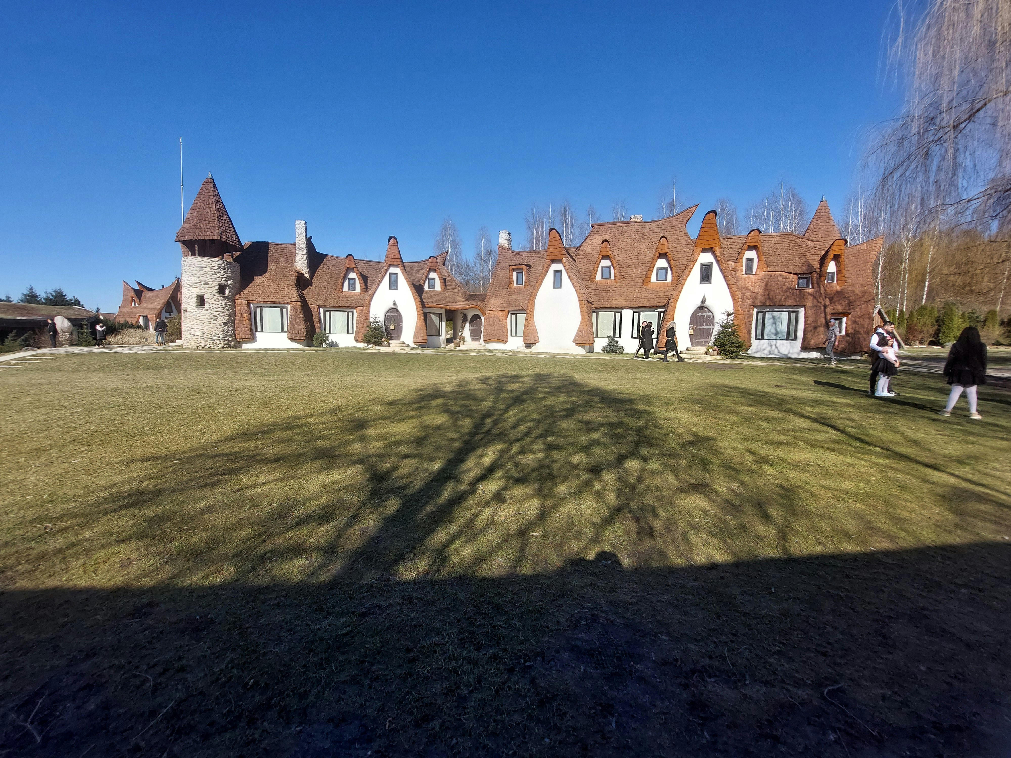 a couple of people standing in front of a house