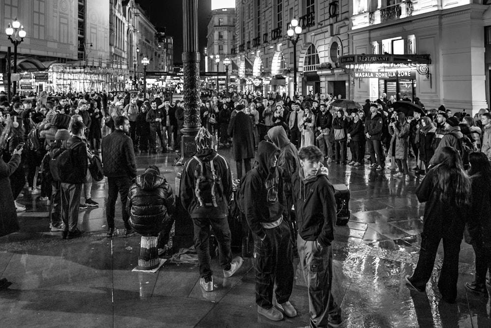 a large group of people standing on a city street