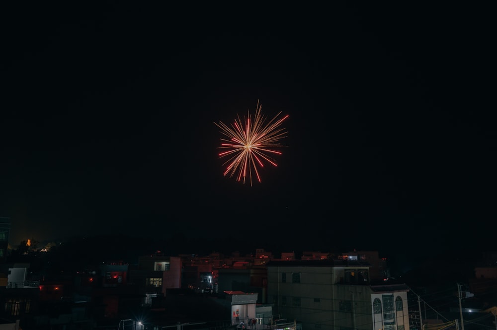 a fireworks is lit up in the night sky