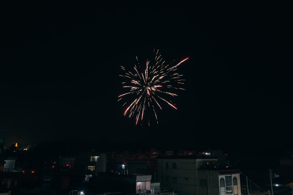 a fireworks display in the night sky over a city