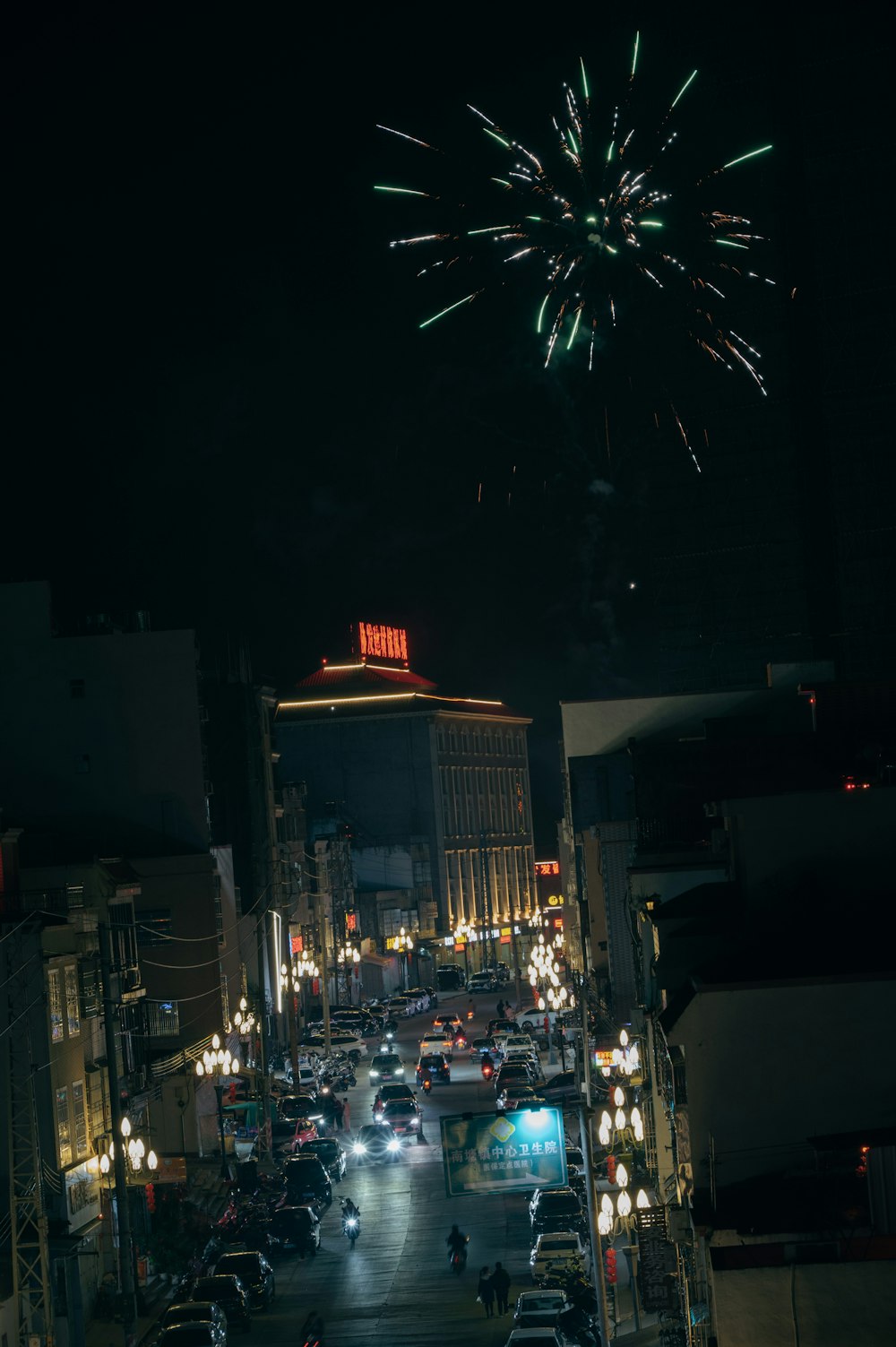 a city street filled with lots of traffic and fireworks