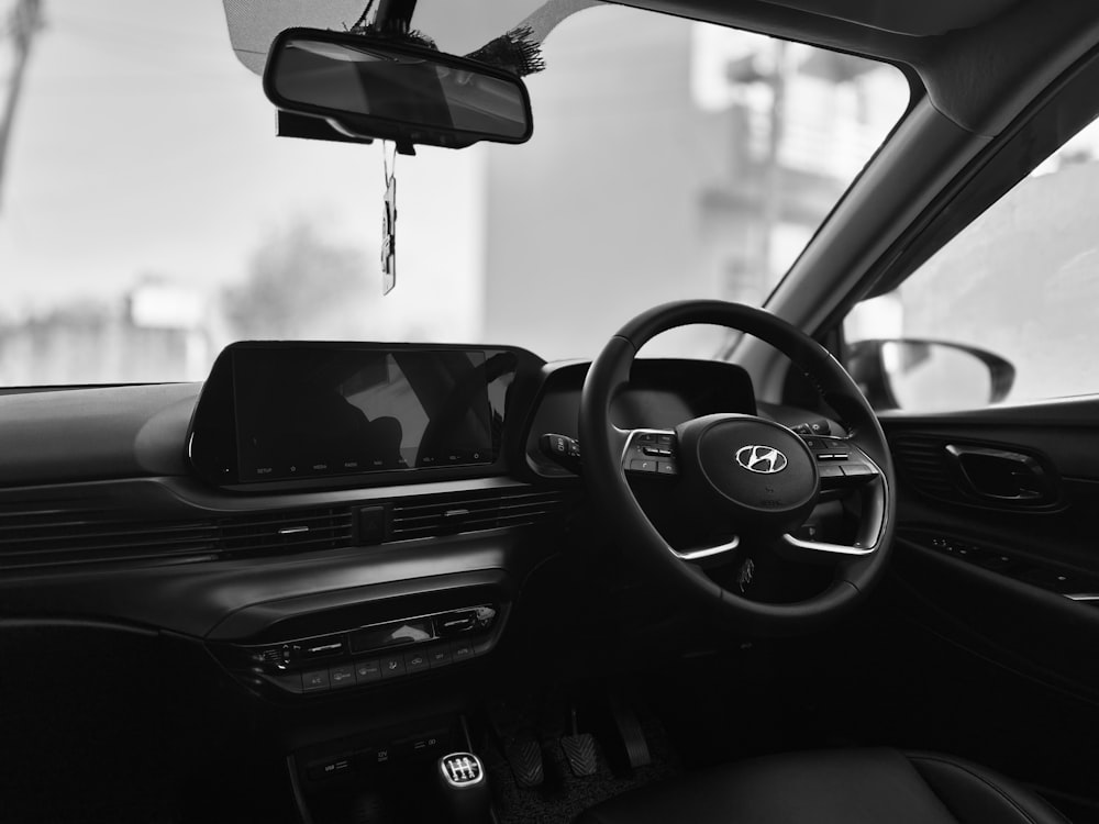 the inside of a car with a dash board and steering wheel