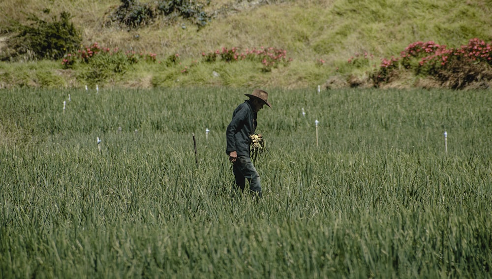 a man standing in a field of tall grass