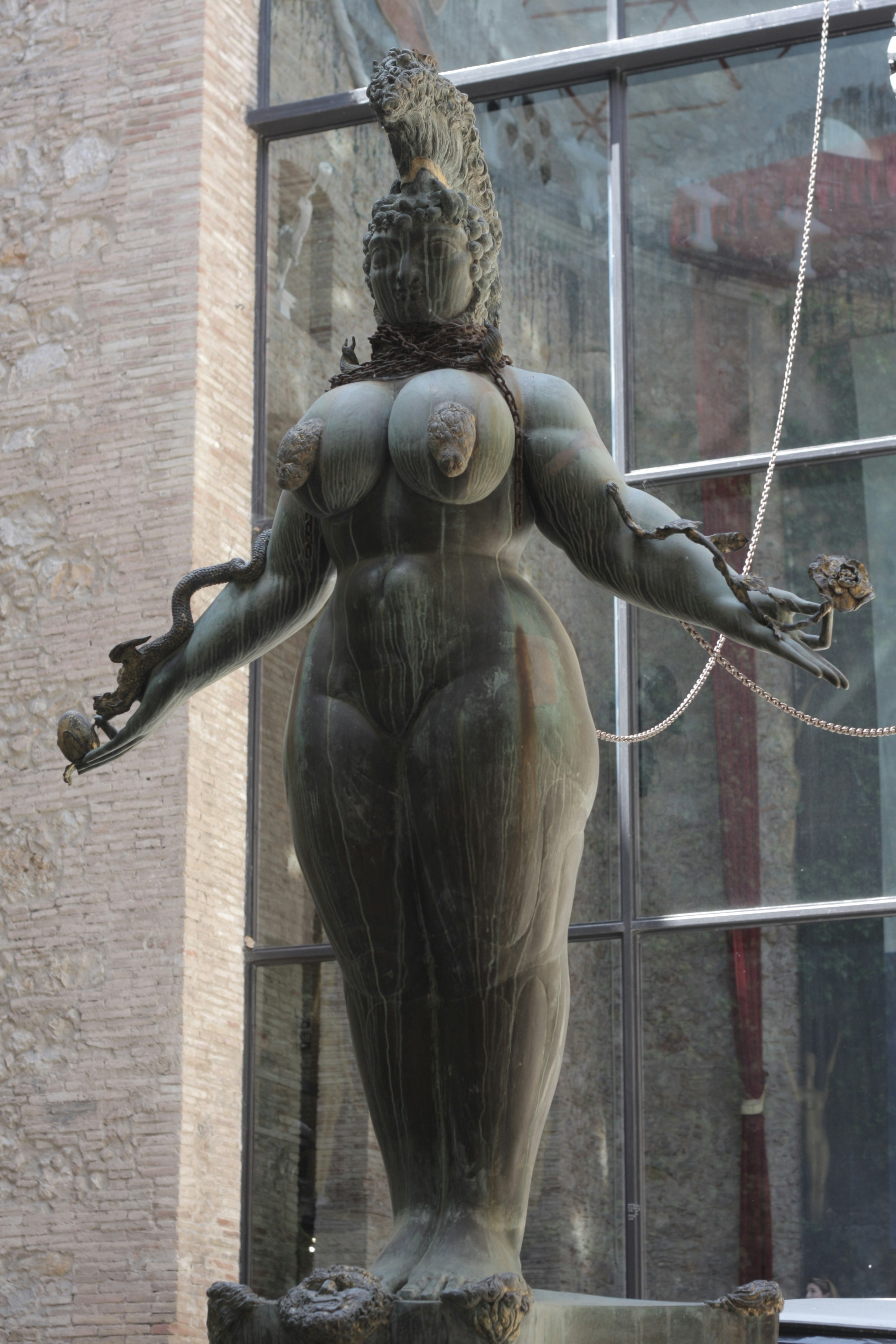 a statue of a woman with a bird on her head
