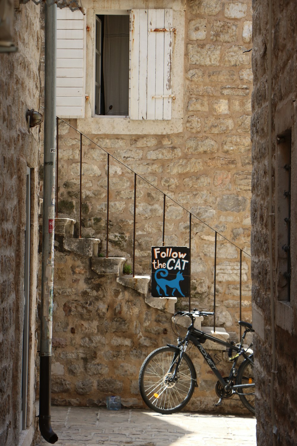 a bicycle parked in front of a stone building
