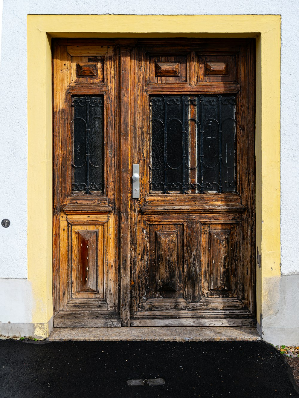 an old wooden door with wrought iron bars