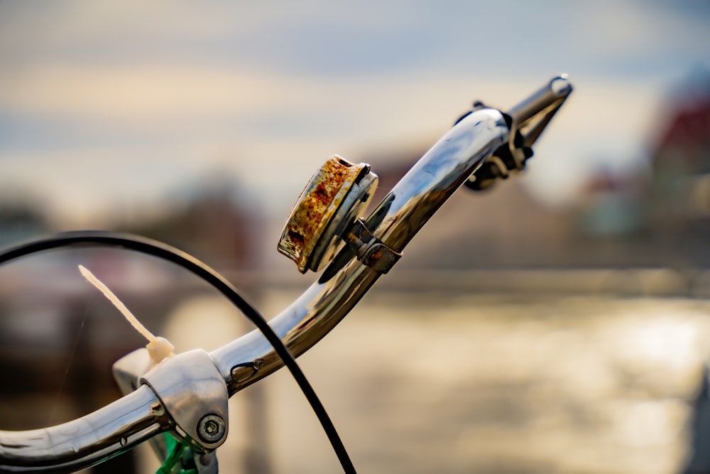 a close up of a bike handlebar with a blurry background
