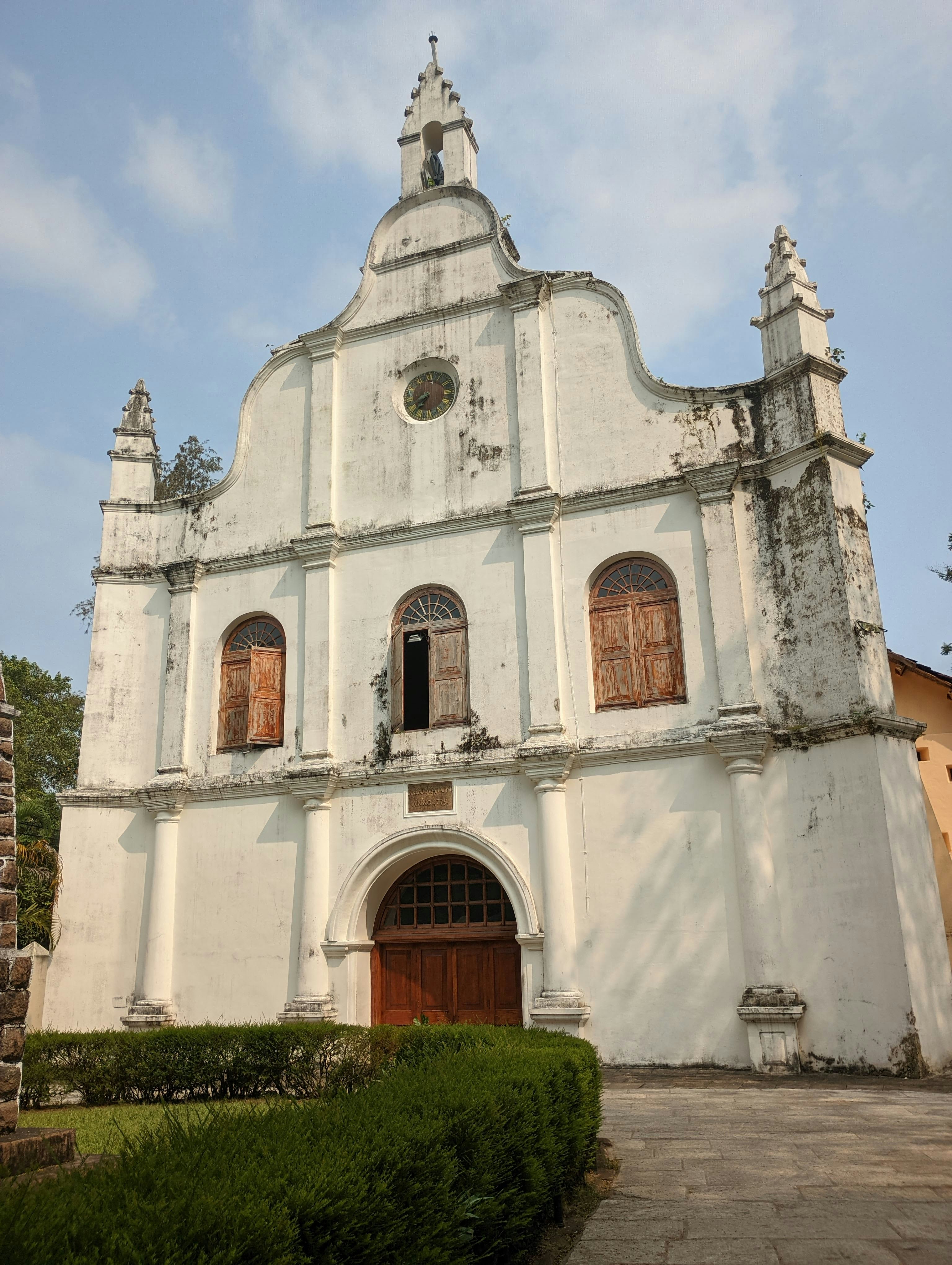 a large white building with a clock on it's side