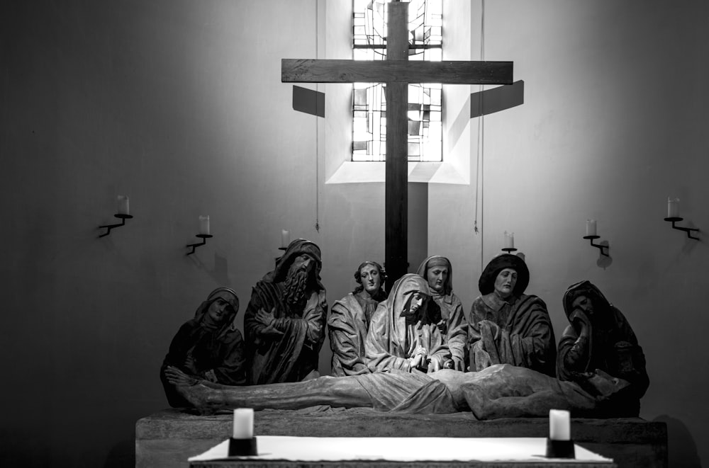 a group of people sitting in front of a cross