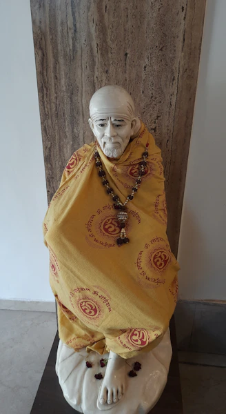 a statue of a man wearing a yellow cloth