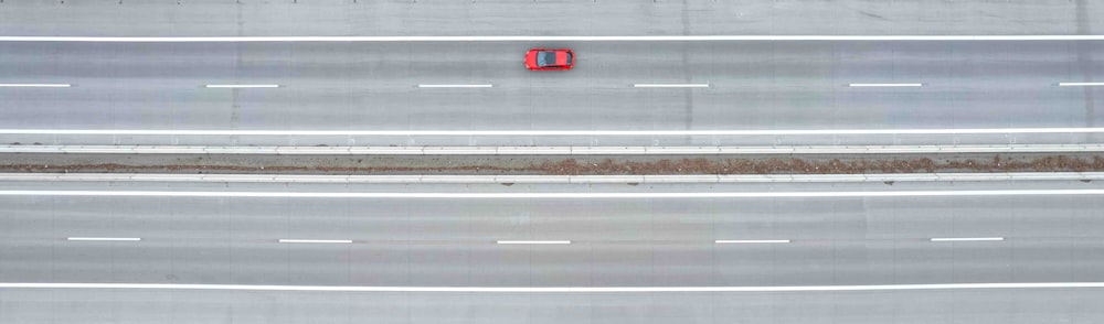 an overhead view of a highway with a red sign on it