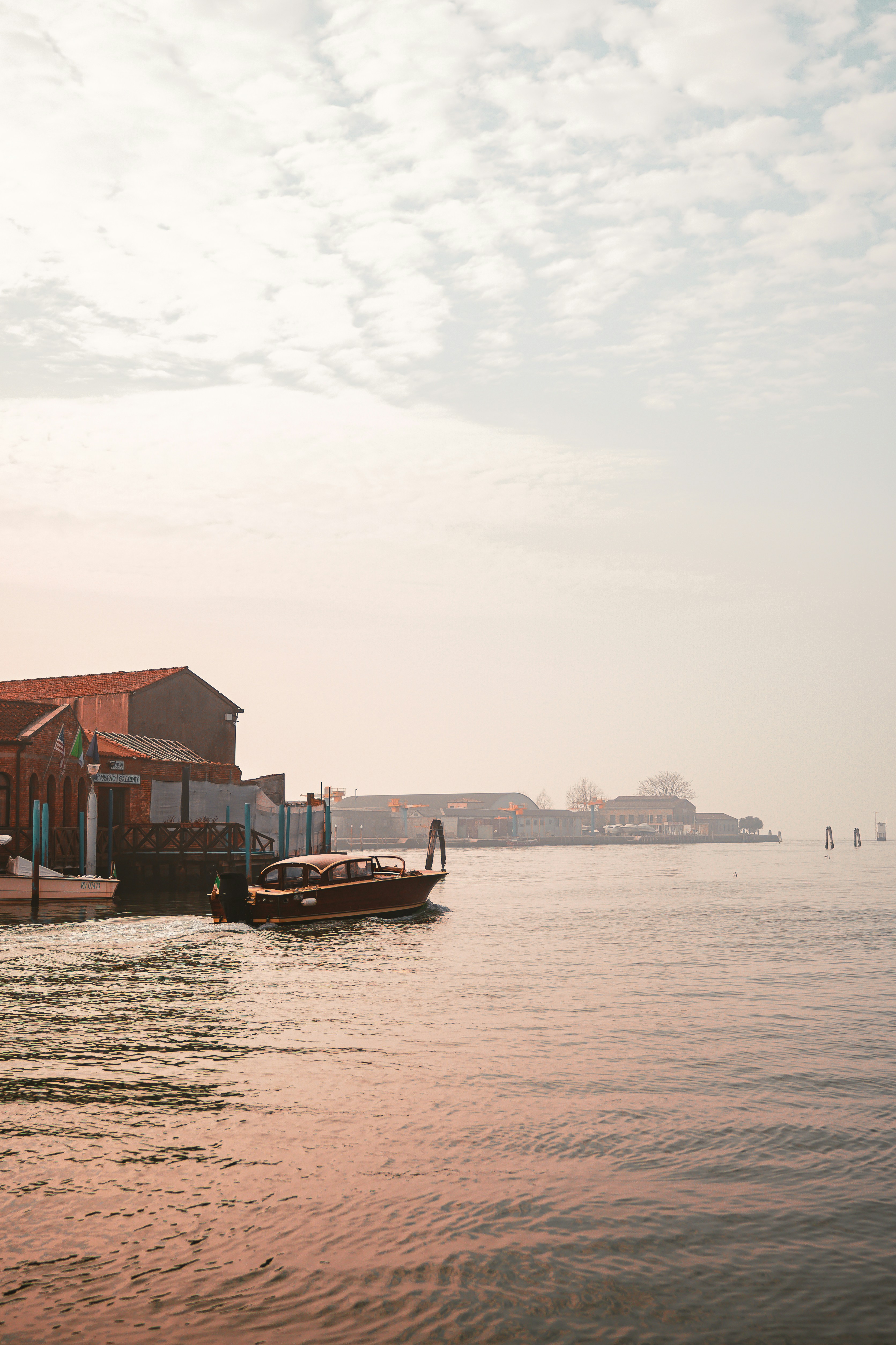 a small boat floating on top of a body of water
