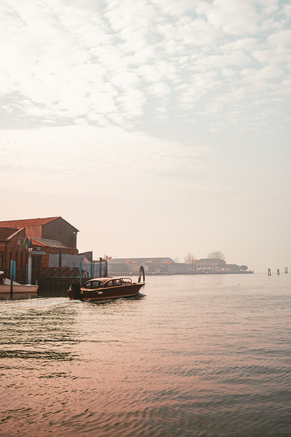 a small boat floating on top of a body of water