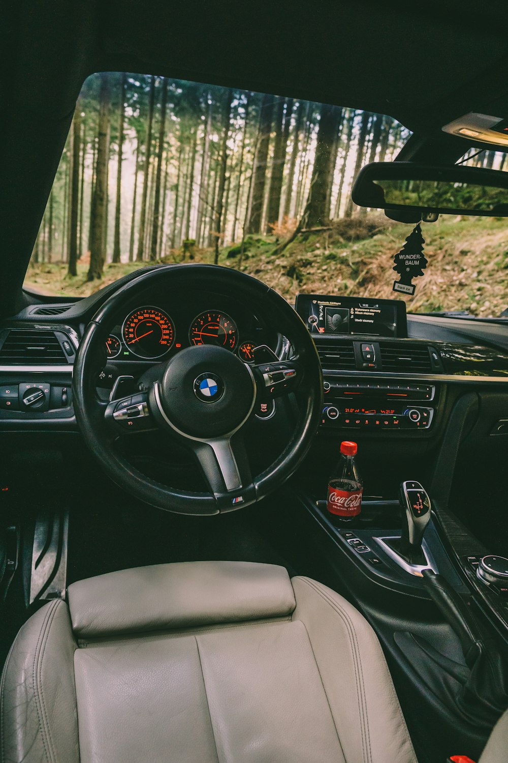 the interior of a car with a dashboard and steering wheel