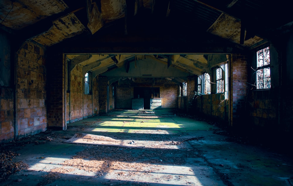an old abandoned building with sunlight coming through the windows