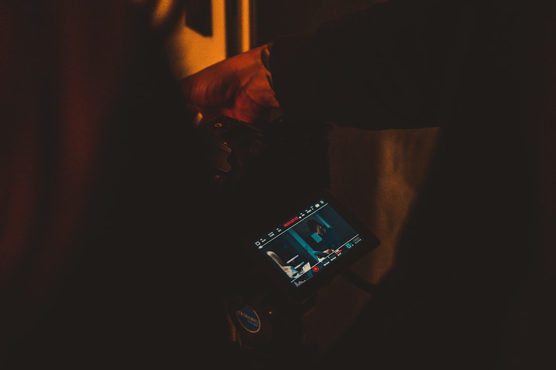 a person holding a cell phone in their hand, Music video production