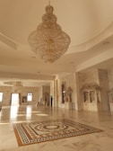 a chandelier hanging from the ceiling in a large room