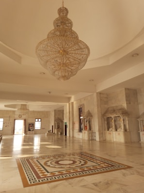 a chandelier hanging from the ceiling in a large room