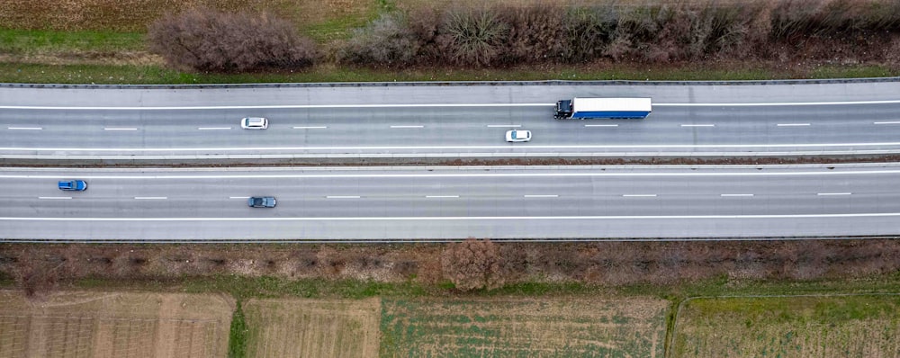 an aerial view of two trucks driving down a highway