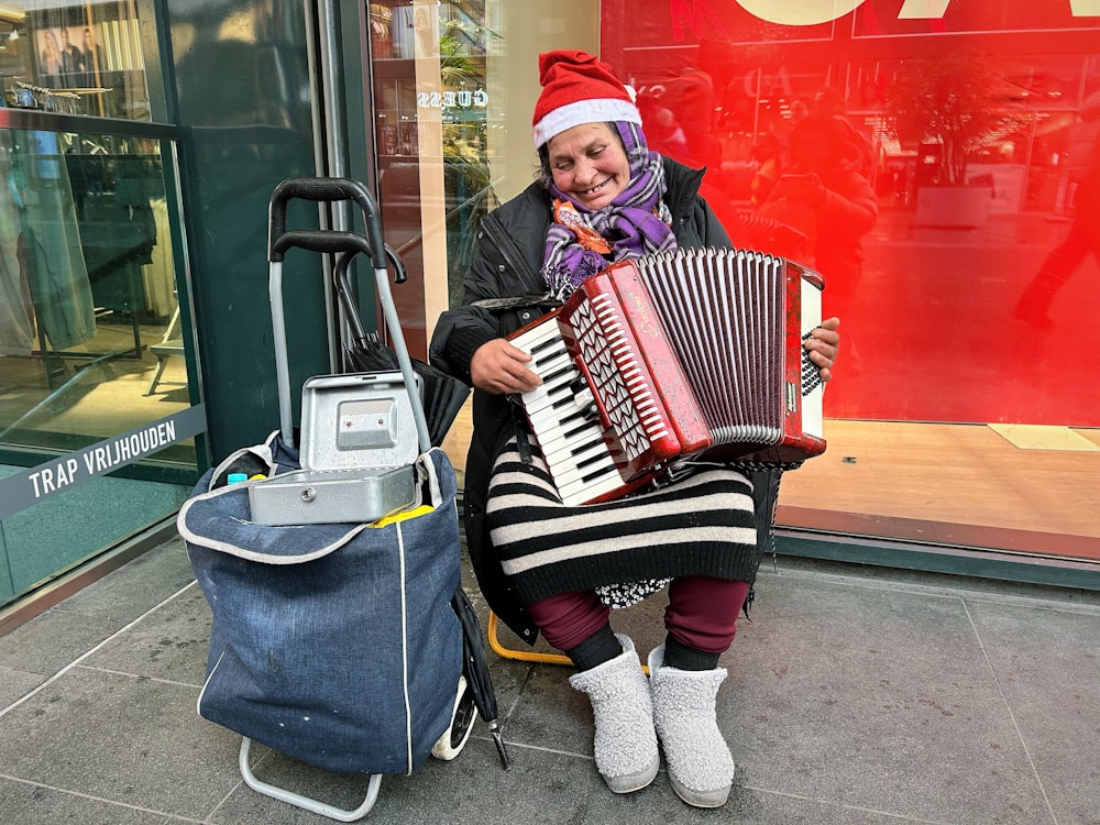 a woman in a santa hat is playing an accordion