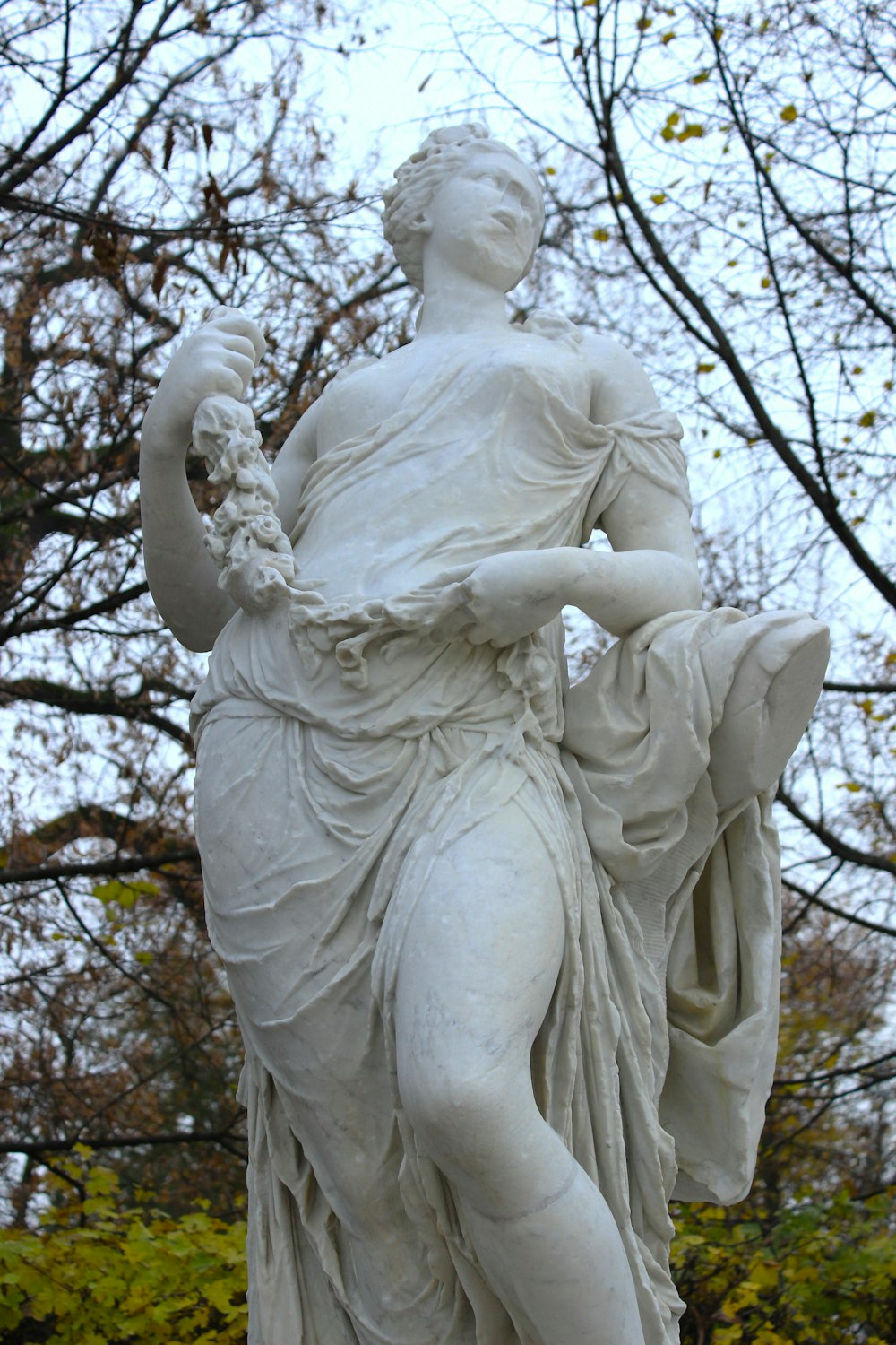 a statue of a woman holding a bird