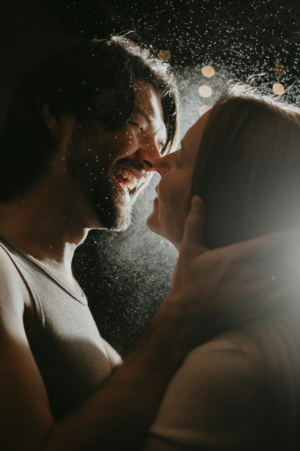 a man and a woman kissing in the rain