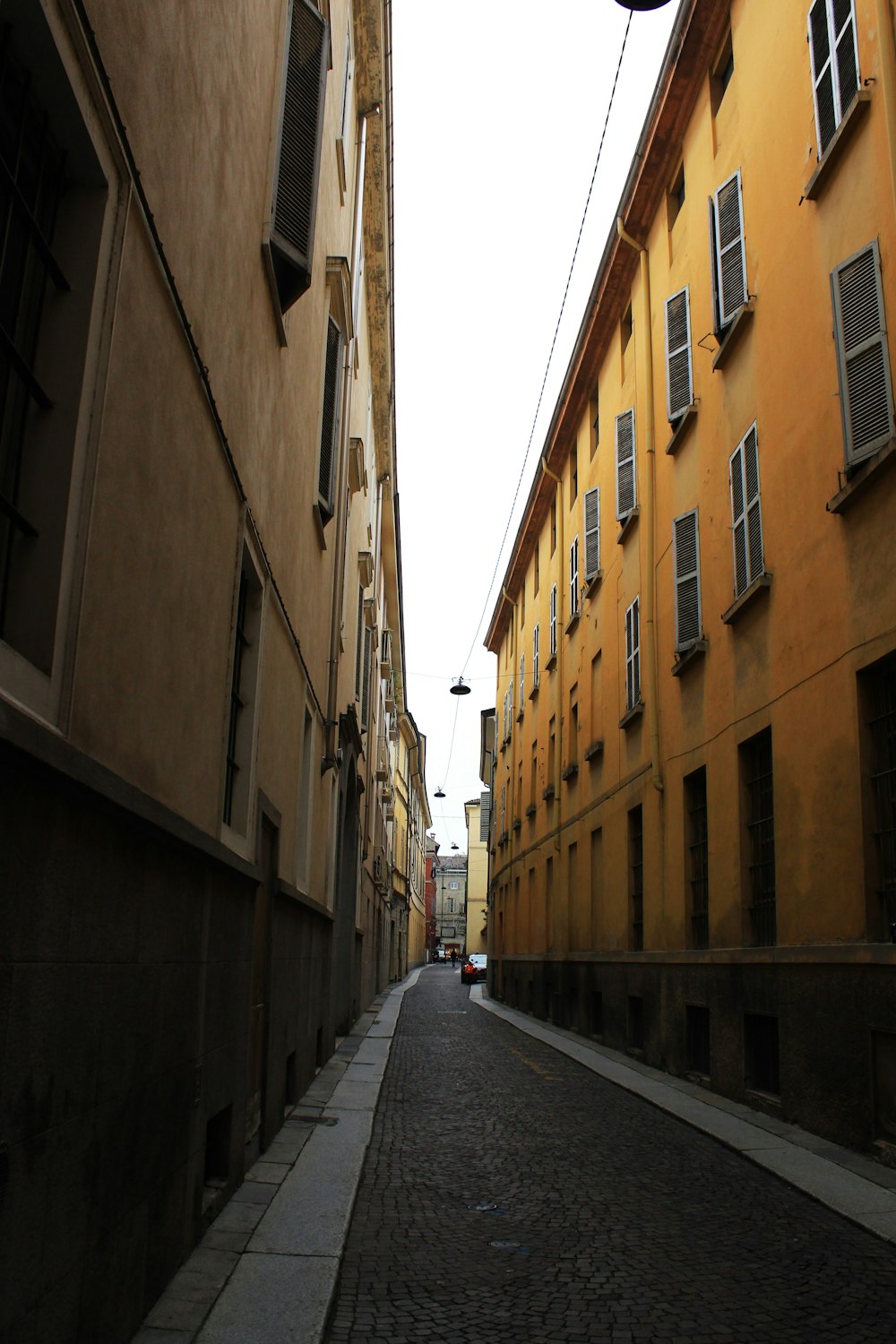 a street with a clock hanging from the side of it