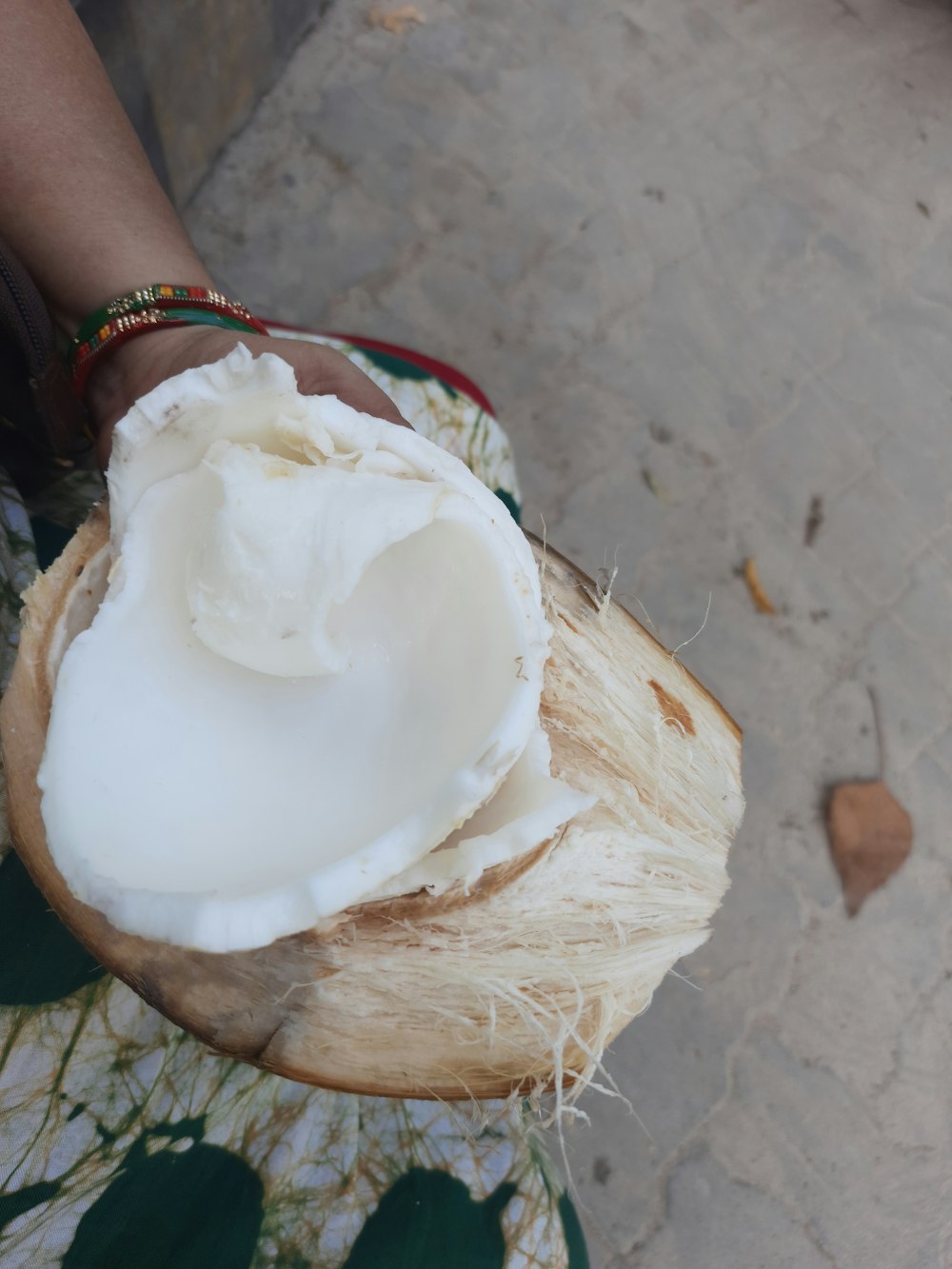 a close up of a person holding a coconut