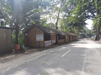 a small shack sitting on the side of a road