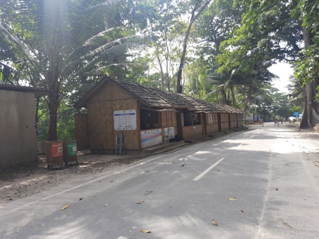 a small shack sitting on the side of a road