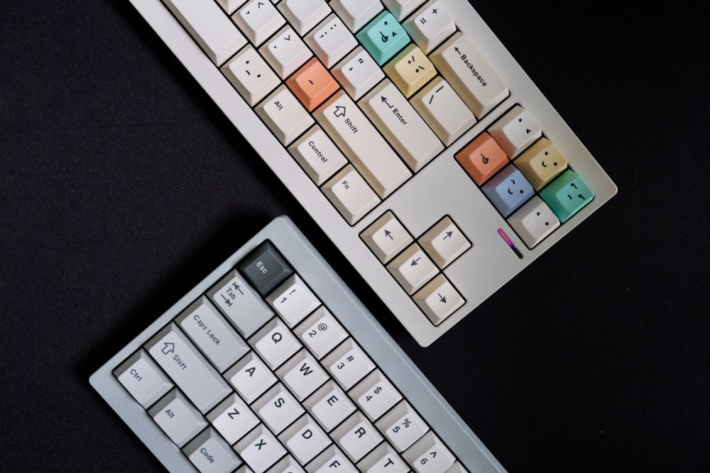 a couple of keyboards sitting next to each other