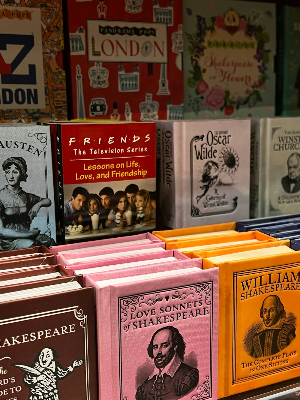 a row of books sitting on top of a shelf