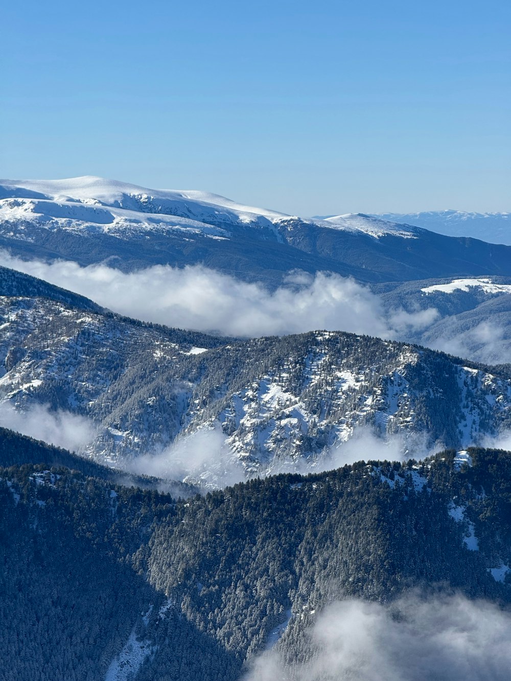 a view of a mountain range covered in snow