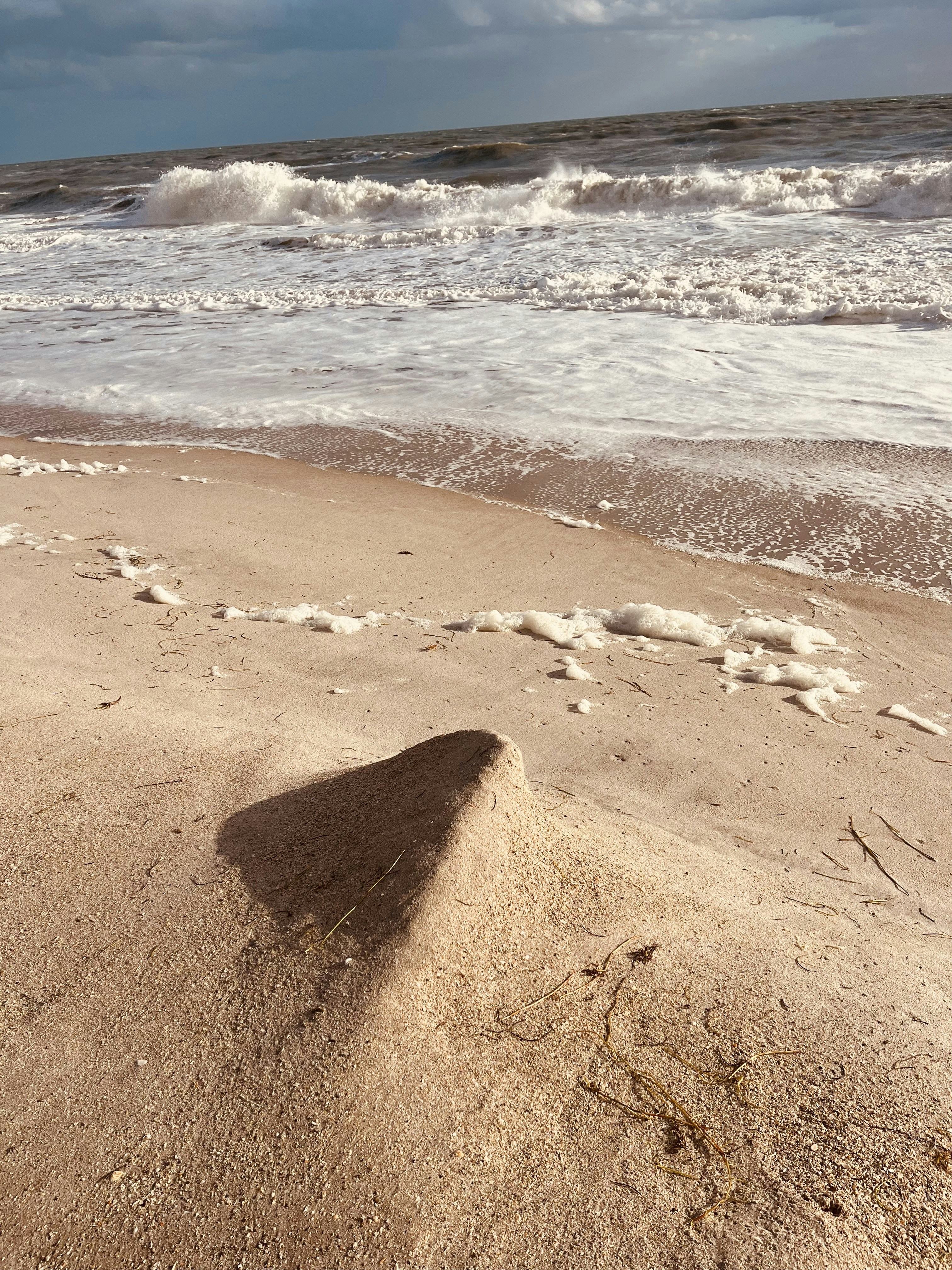 a shadow of a person standing on a beach