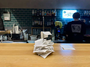 a stack of papers sitting on top of a wooden counter