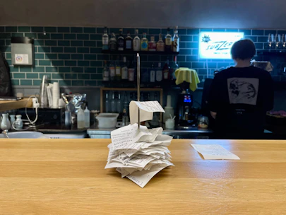 a stack of papers sitting on top of a wooden counter