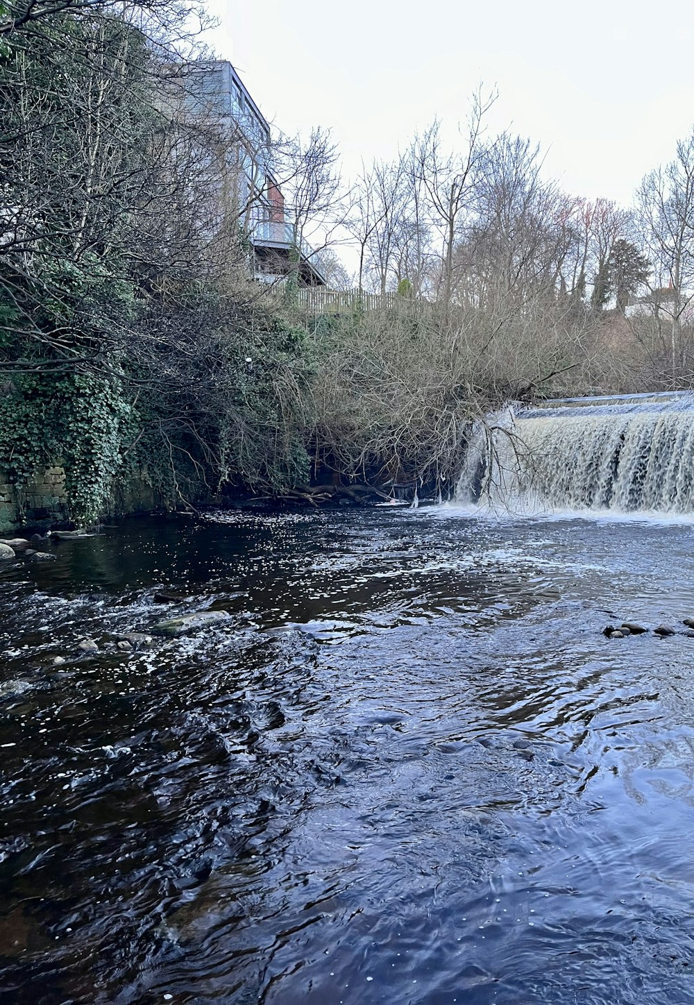 a small waterfall in the middle of a river