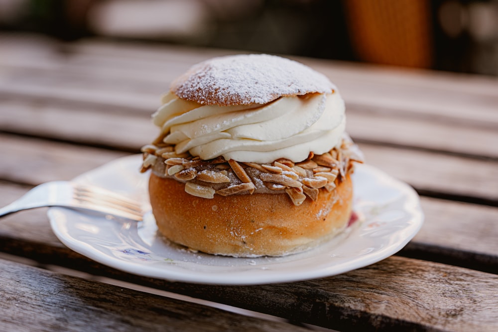 a pastry on a plate with a fork on a table