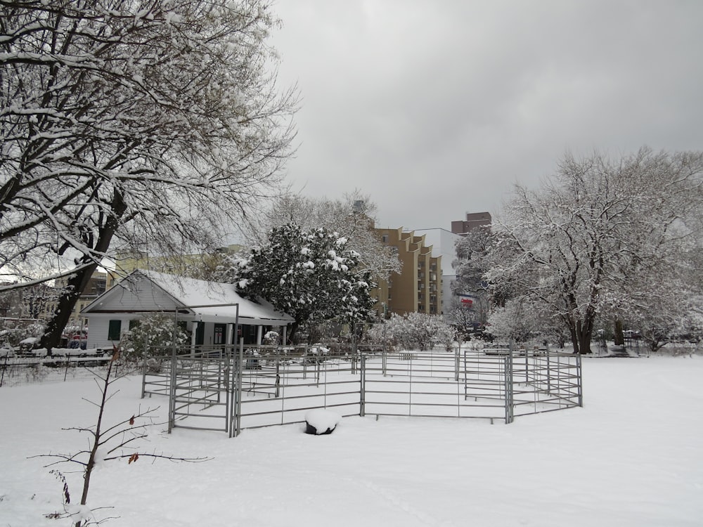 a snow covered field with a building in the background