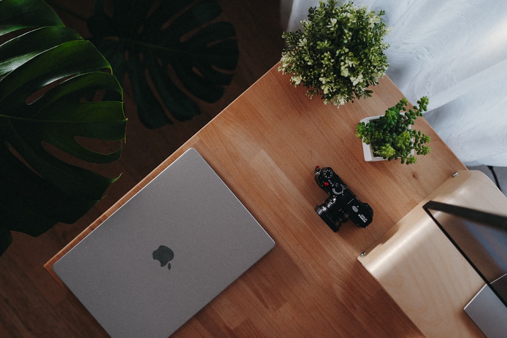 a laptop computer sitting on top of a wooden table