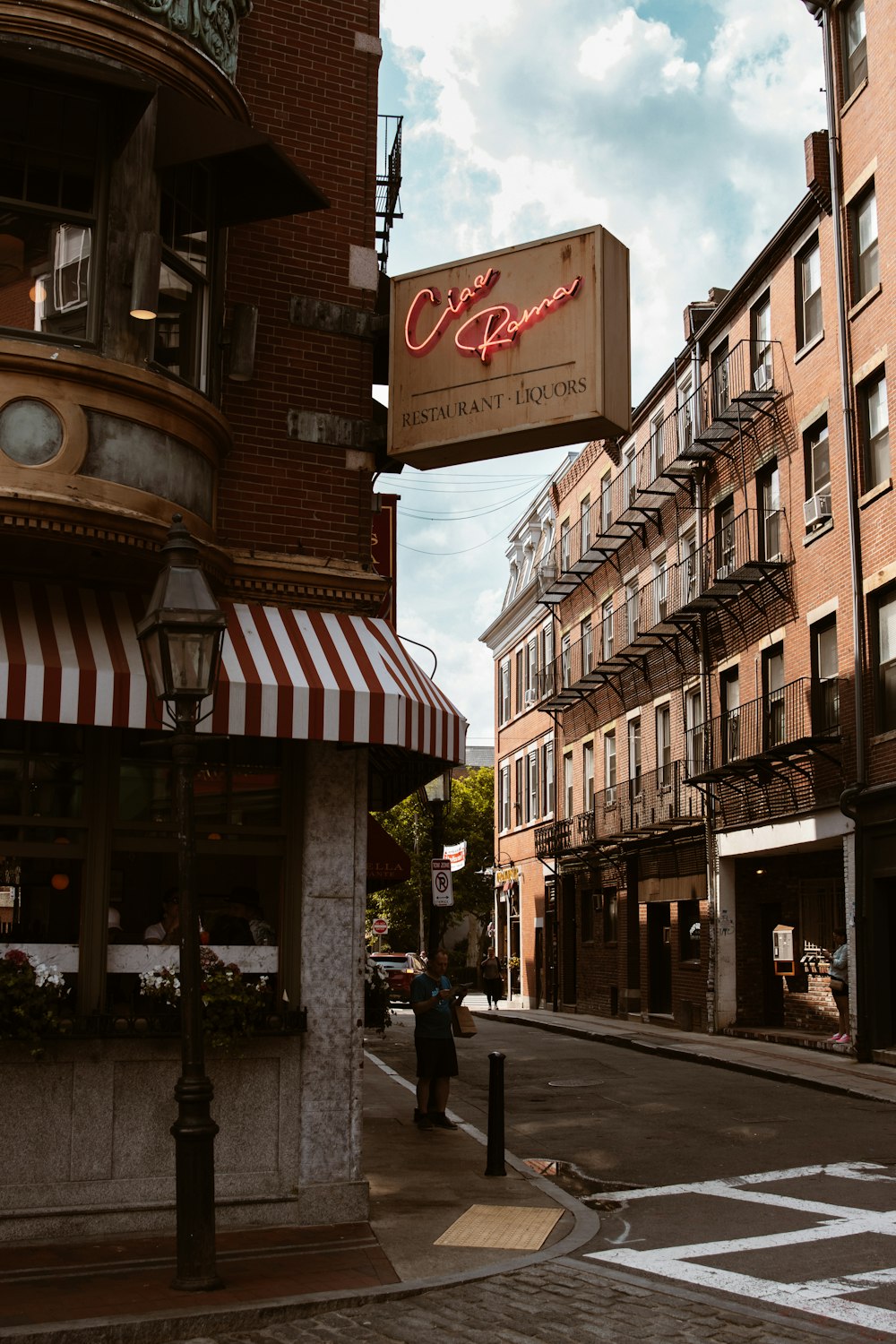 a city street with a sign for a restaurant