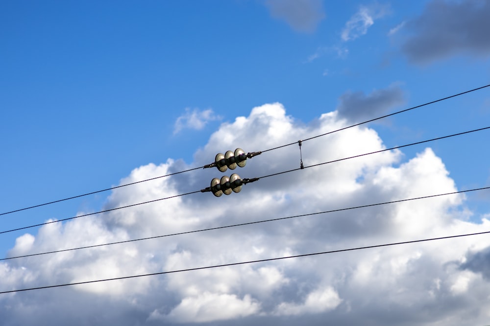 a couple of traffic lights sitting on top of power lines