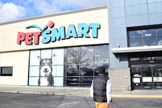 a man walking past a pet smart store