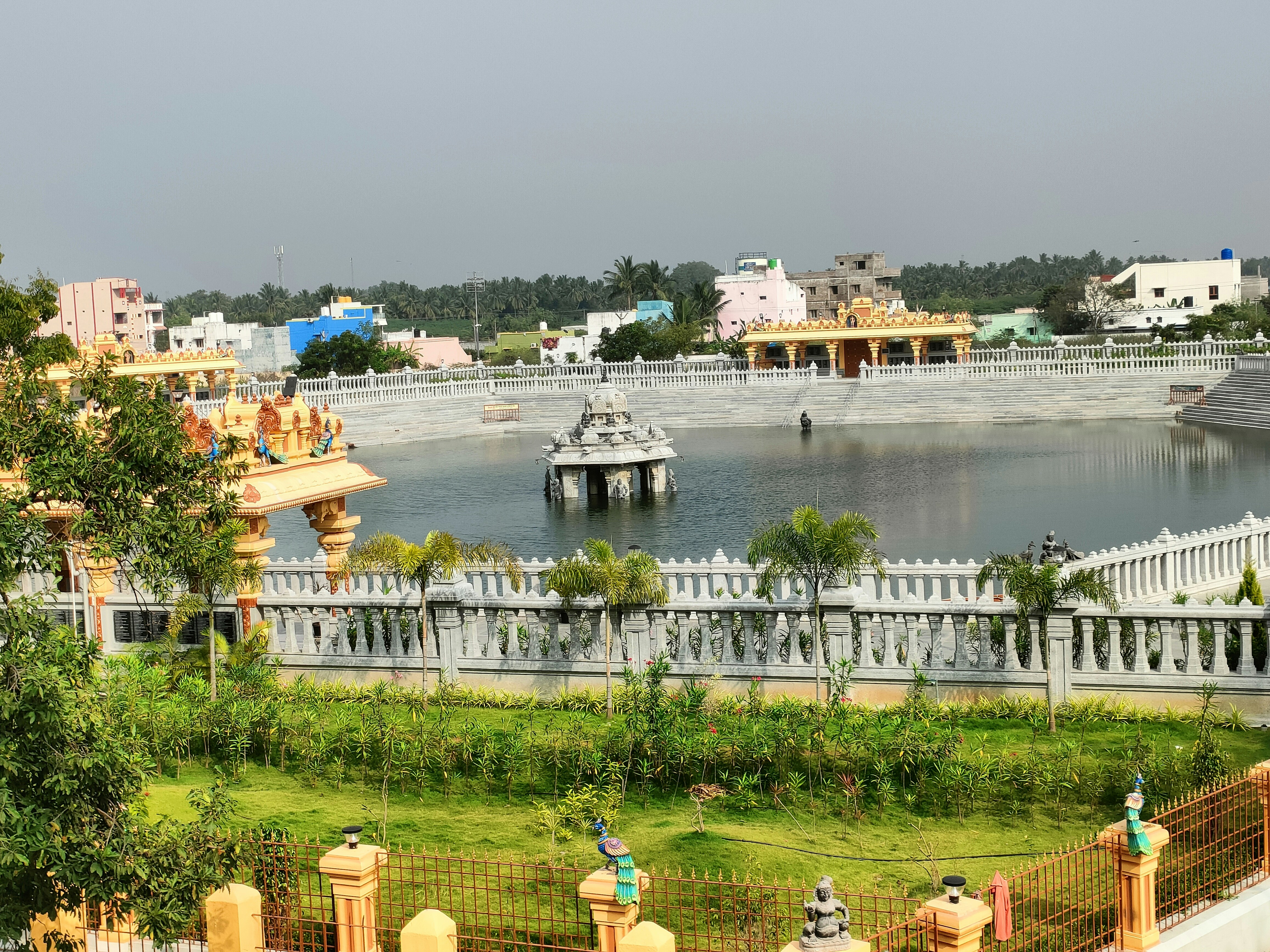 a large body of water next to a lush green park