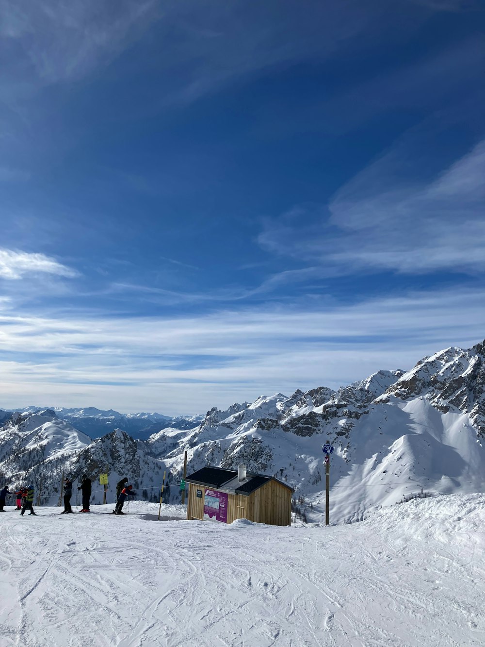 a group of people standing on top of a snow covered slope