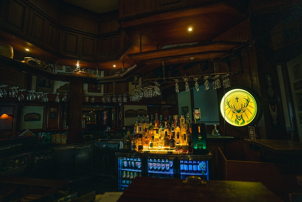 a dimly lit bar with bottles of alcohol